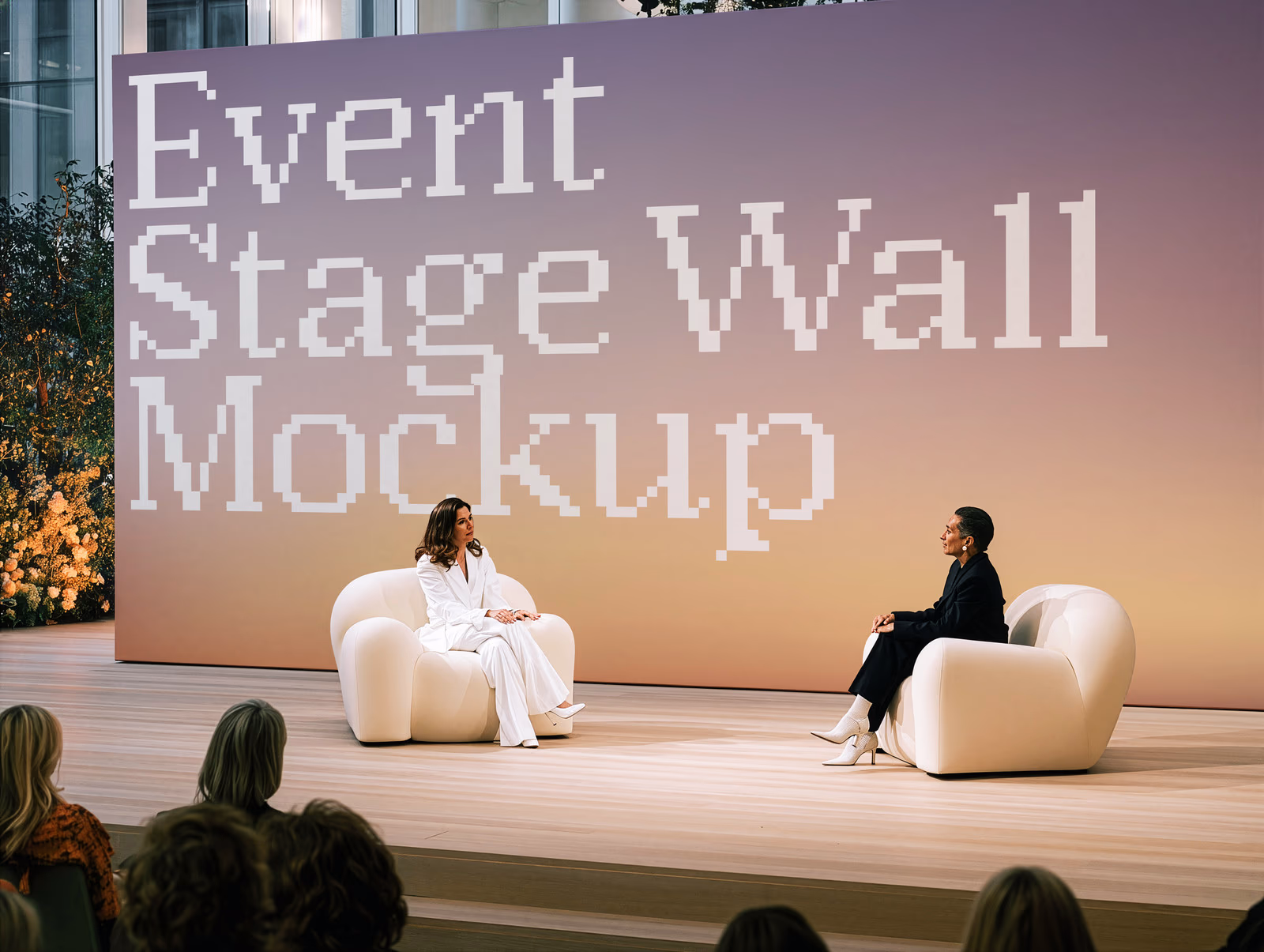 A large conference stage screen showing the SedShop.Co logo behind two speakers on a stage with an audience.