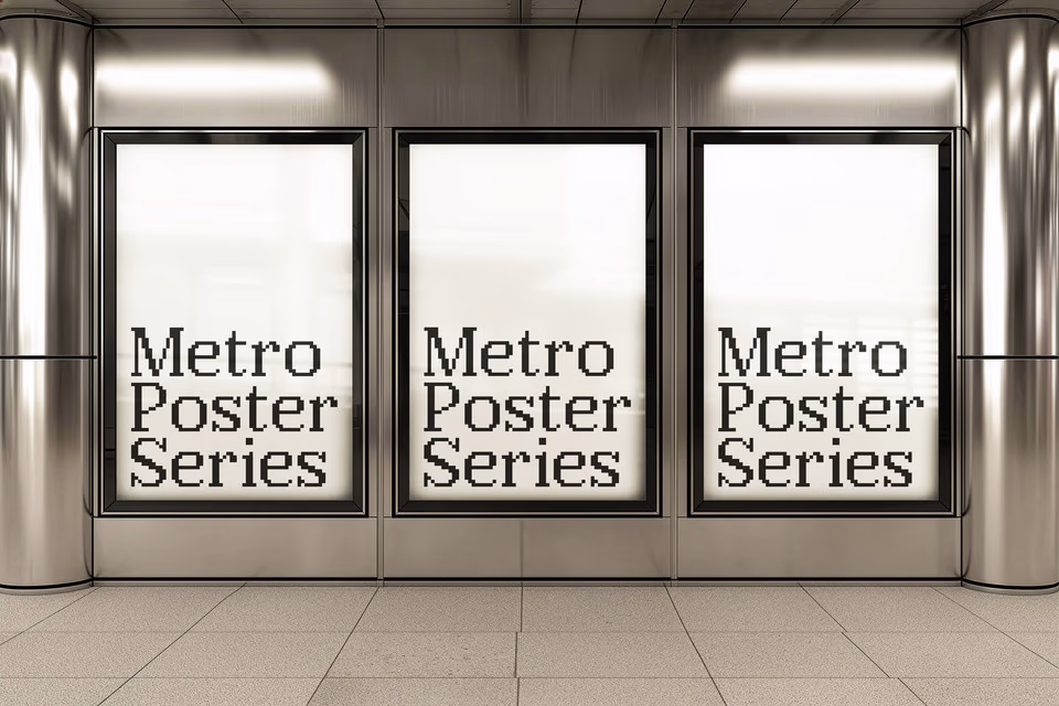 Three backlit citylight poster panels showing a warm gradient design in a polished metallic interior.