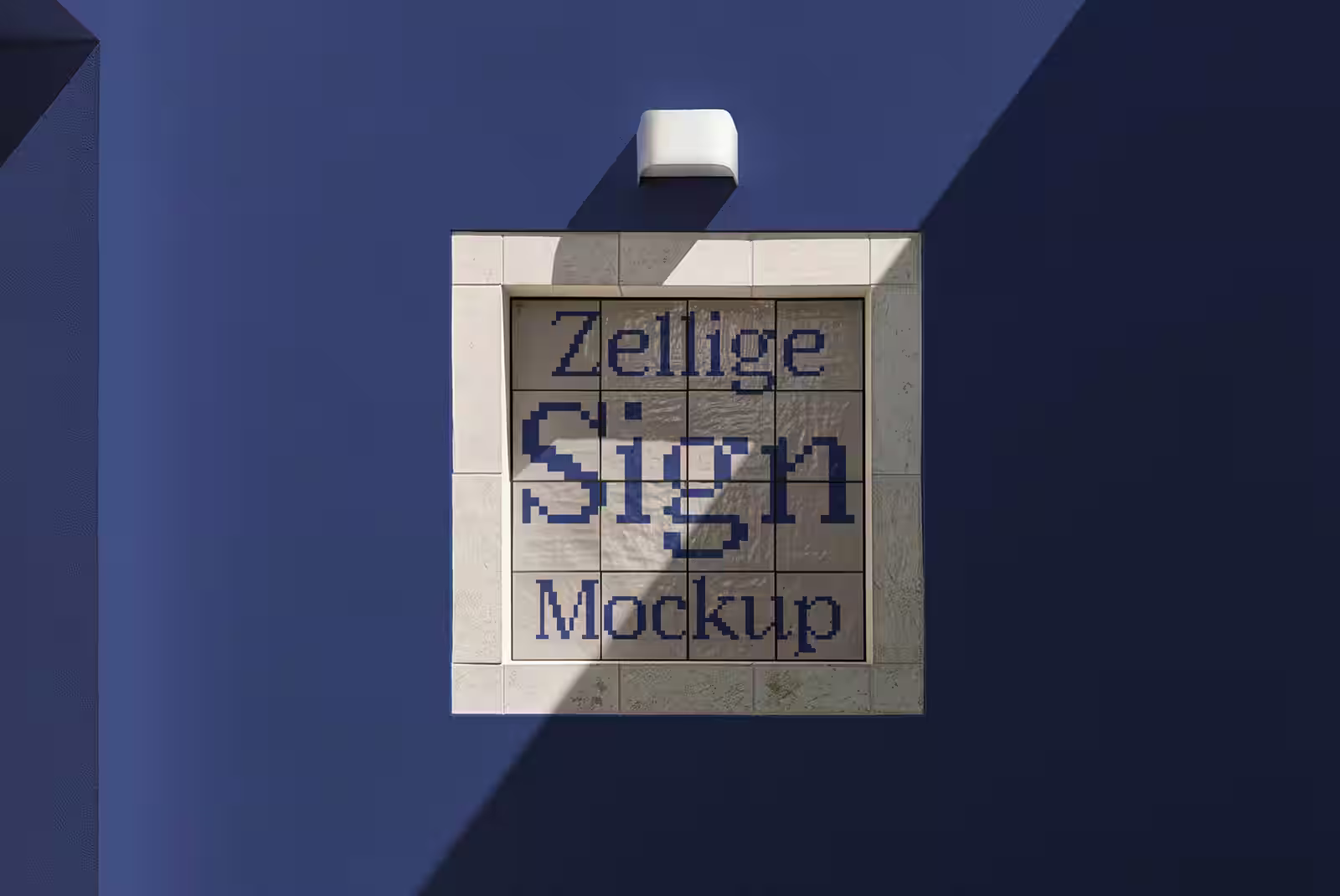 A glazed zellige tiled sign with a warm gradient design on a sunlit plaster wall.