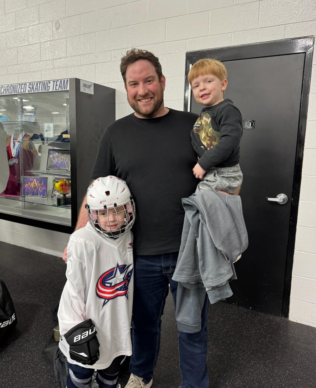Woodside Ventures VP of Client Strategy & Success Derek Ulsh sharing his love of hockey with his children