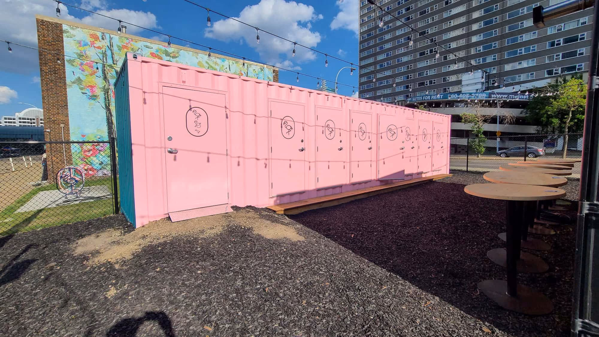 bespoke washroom conversion with pink shipping containers in an event space