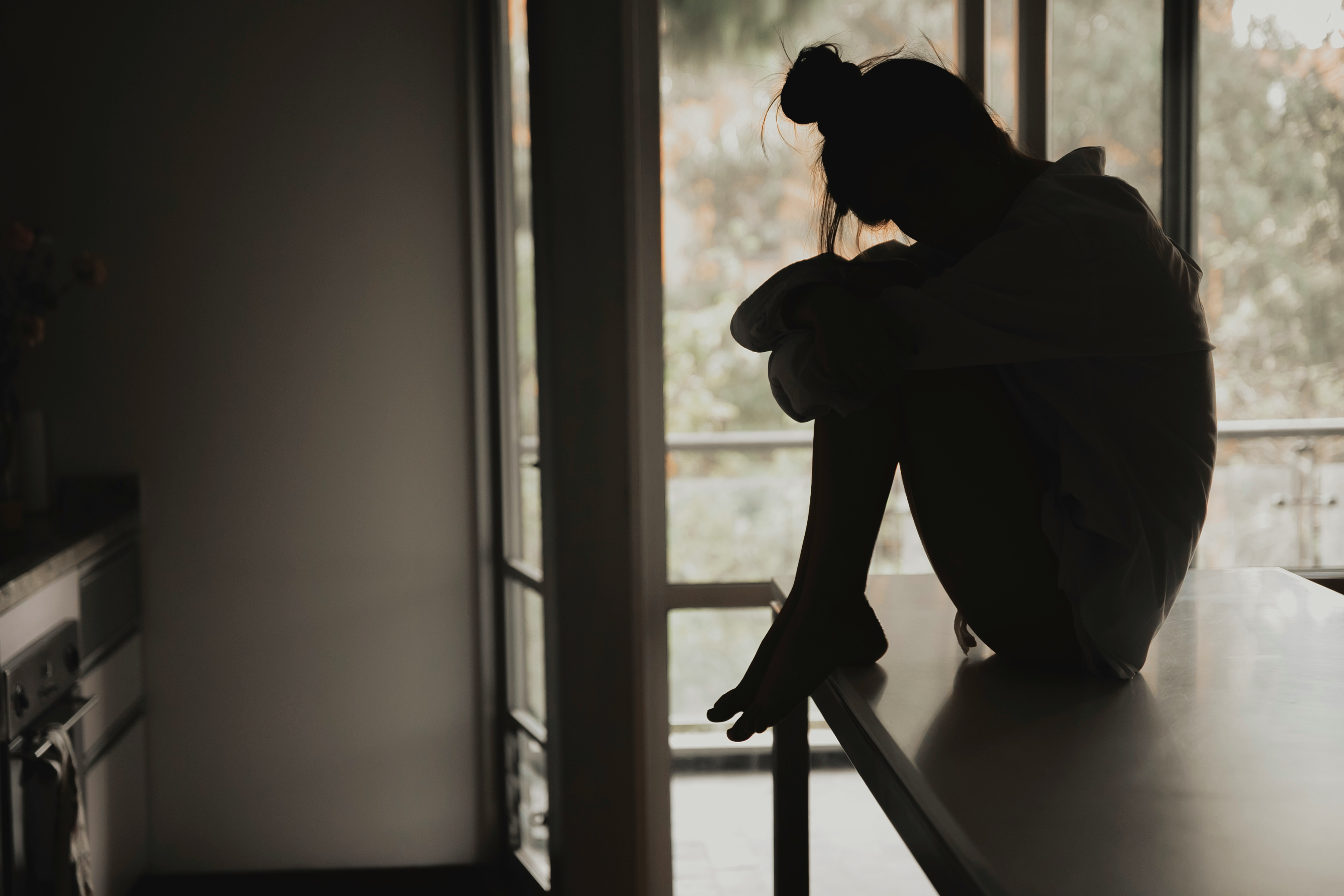 Cabana Suicide Prevention Awareness Month sad woman sitting on the counter