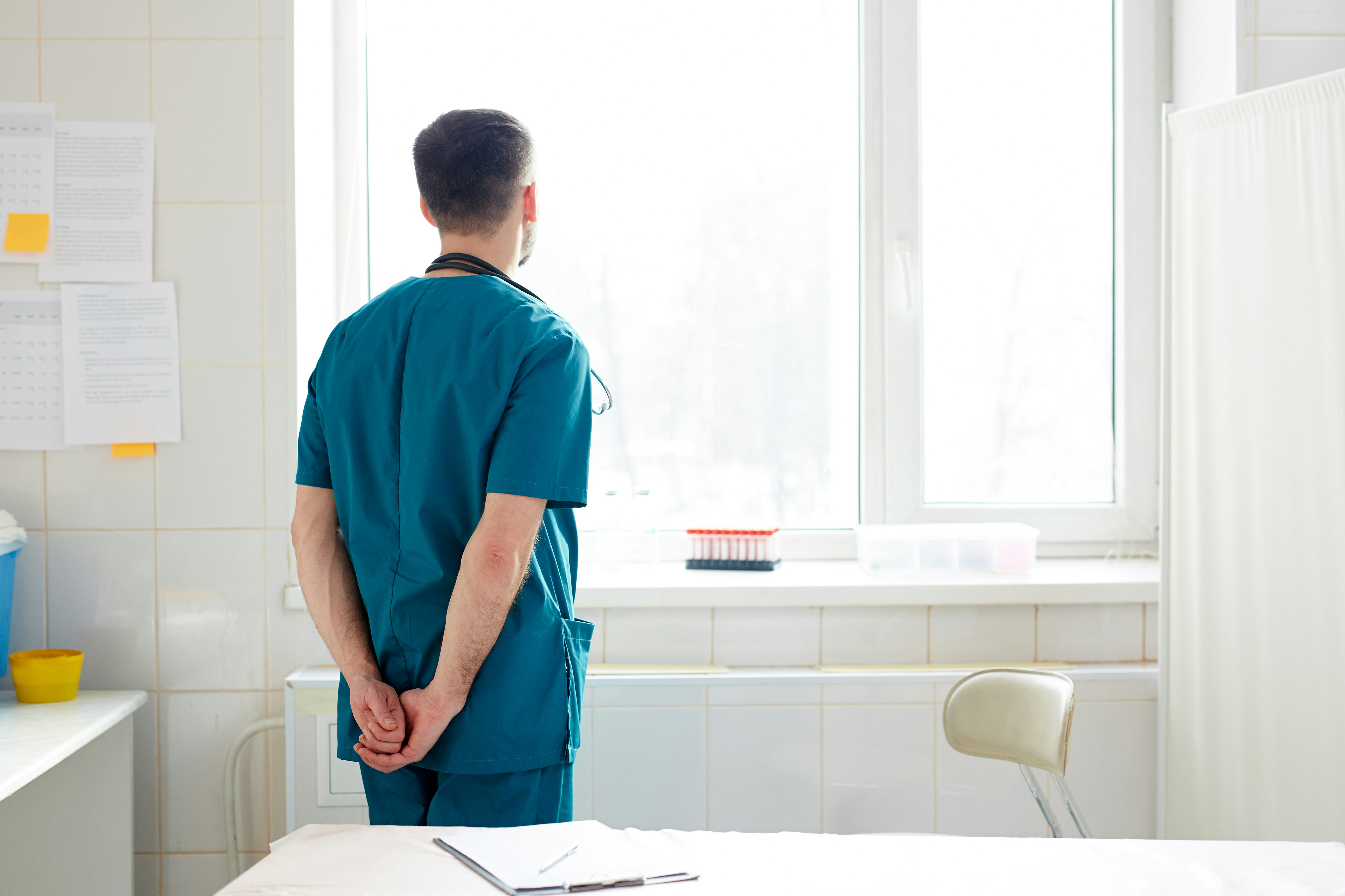 Connected Care (CoCM) male nurse looking out the window