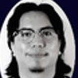 Black and white close-up photo of a person with glasses and long hair.