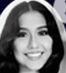 Black and white close-up of a smiling young woman with long dark hair.