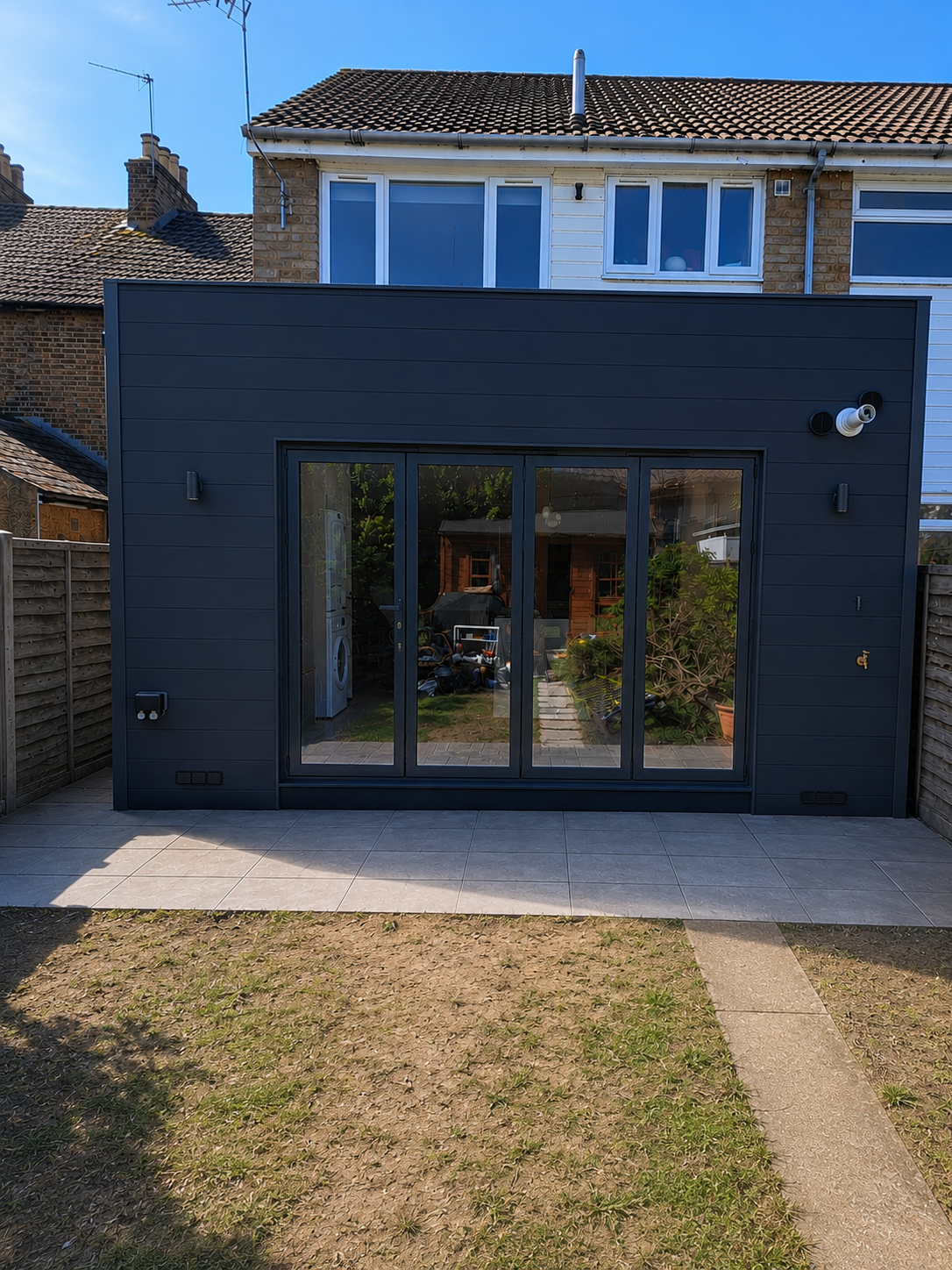 Completed rear extension exterior with Hardieplank cladding and aluminium bifold doors, Walthamstow E17