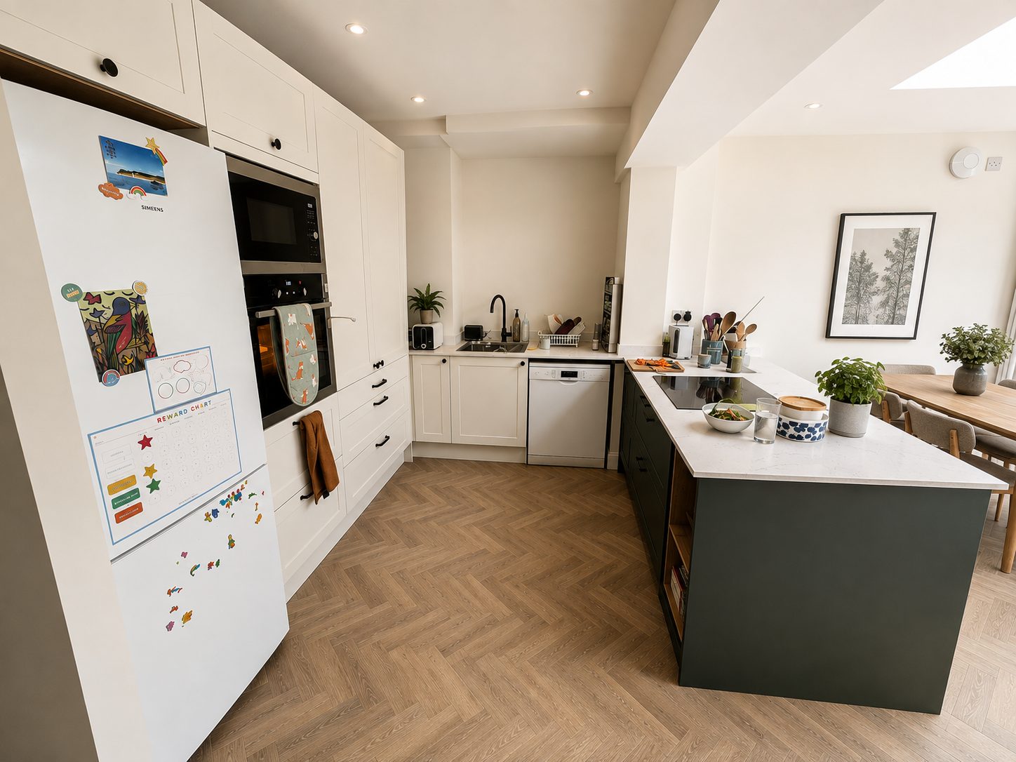 Two-tone kitchen with island and herringbone flooring installed in the rear extension, East Oxford OX4