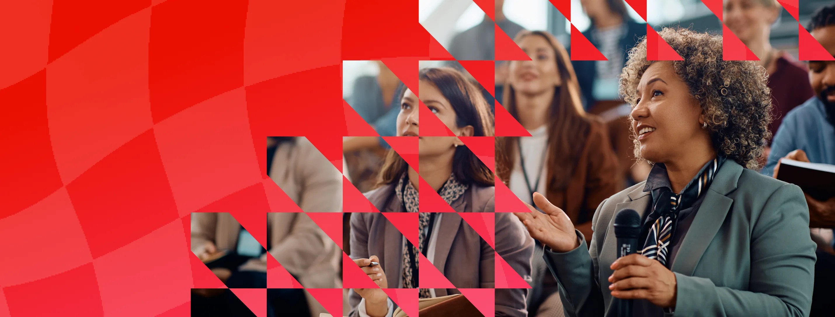 Adobe event audience with a speaker holding a microphone, framed by a red geometric pattern