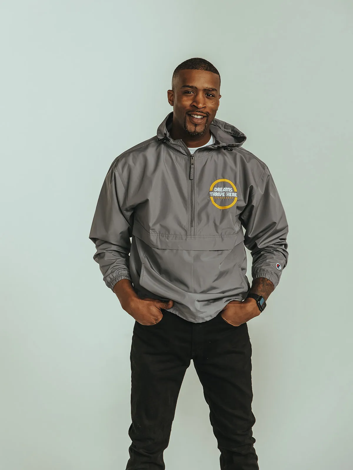 A male model wearing the Dreamers Windbreaker product.
