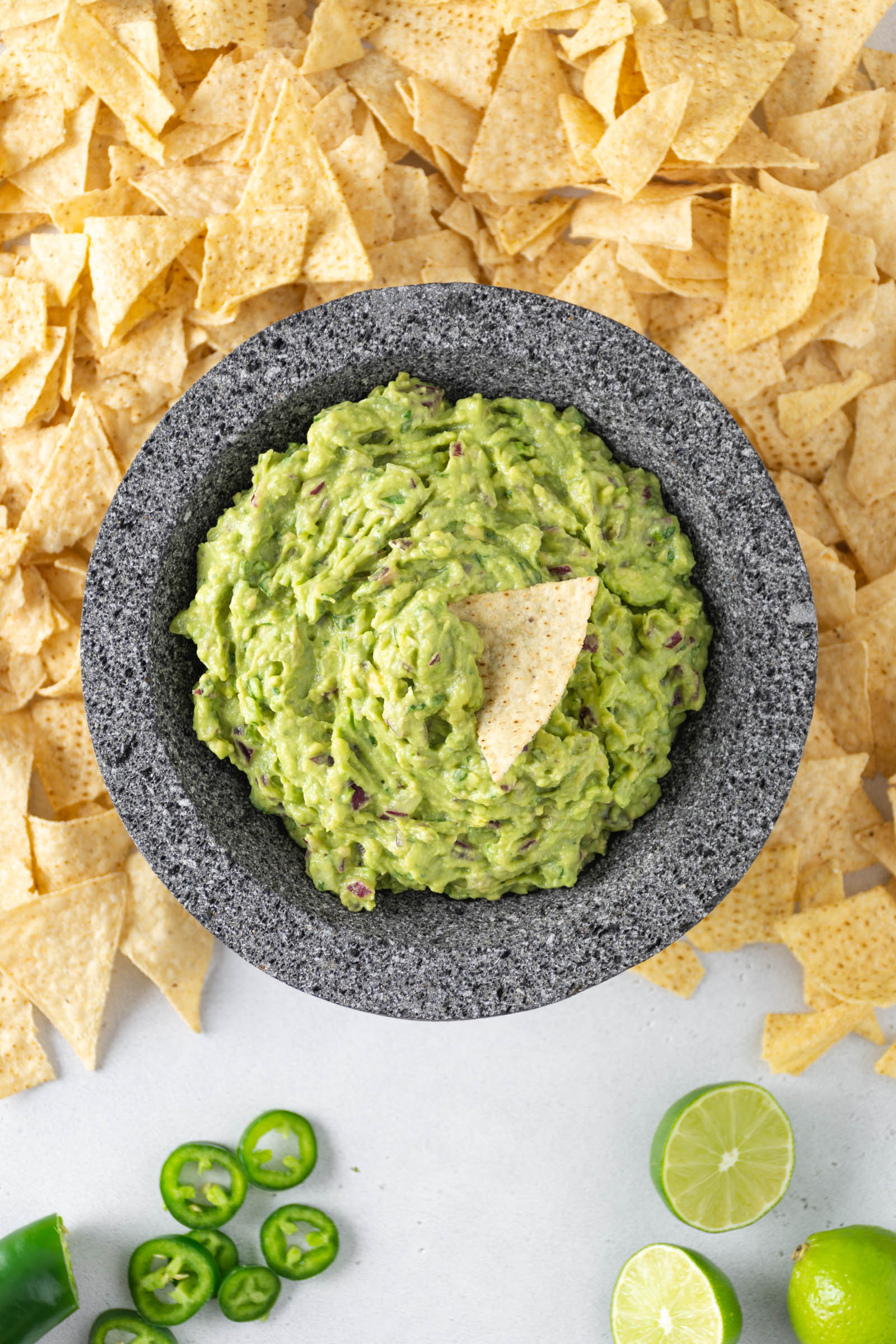 A tortilla chip in guacamole.