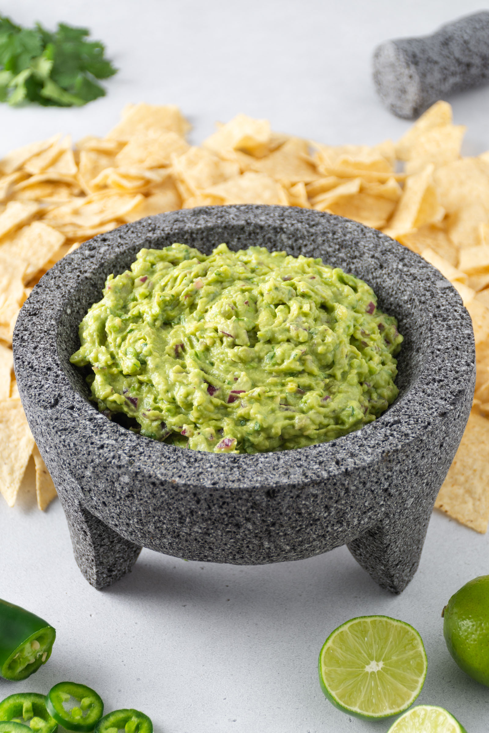 Guacamole, tortilla chips and limes.