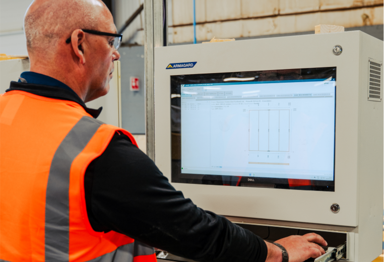A person in an orange vest using a computerAI-generated content may be incorrect.
