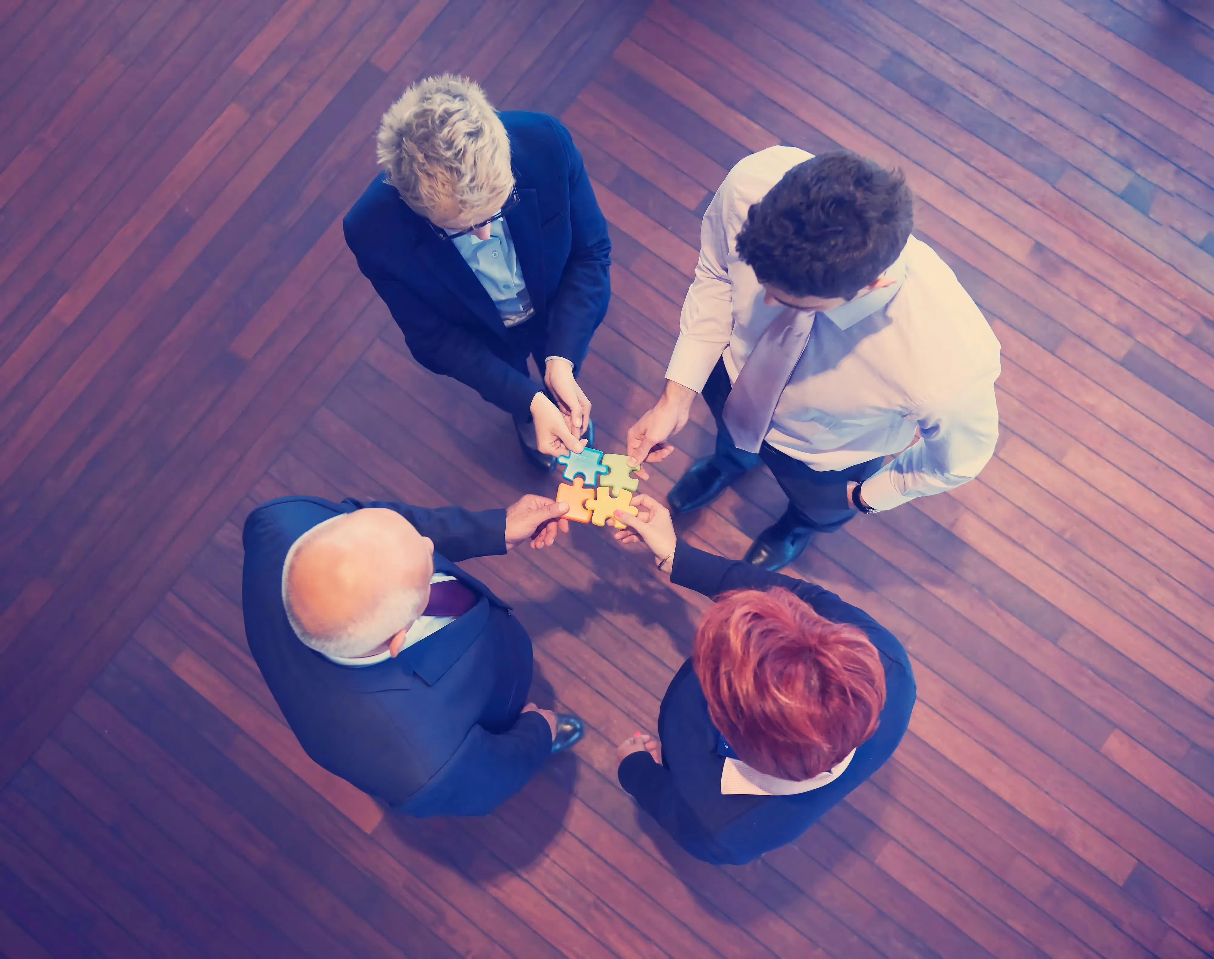 Three people are holding a puzzle together. - UserVoice Images