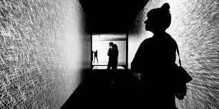 A woman standing alone in a dark alleyway - UserVoice Images 
