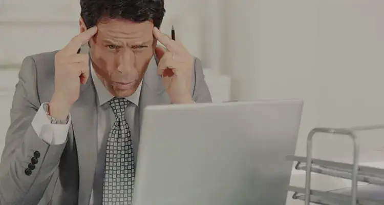 A man in a suit with his hands on his head. - UserVoice Images