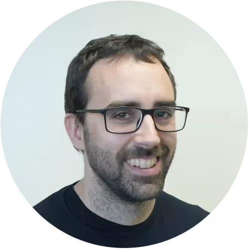 A man wearing glasses and a black shirt.