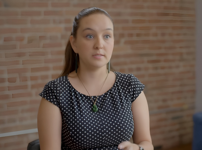 A woman wearing a polka dot shirt and a necklace. - UserVoice Images