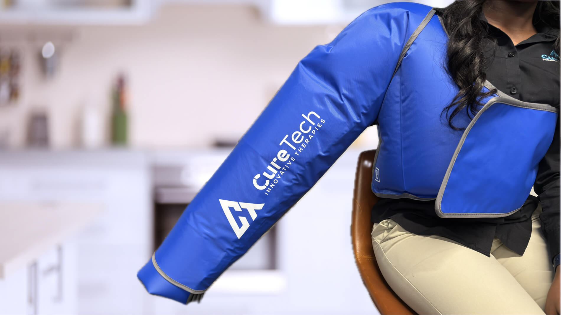 Person wearing a blue CureTech arm compression sleeve designed for therapeutic use.