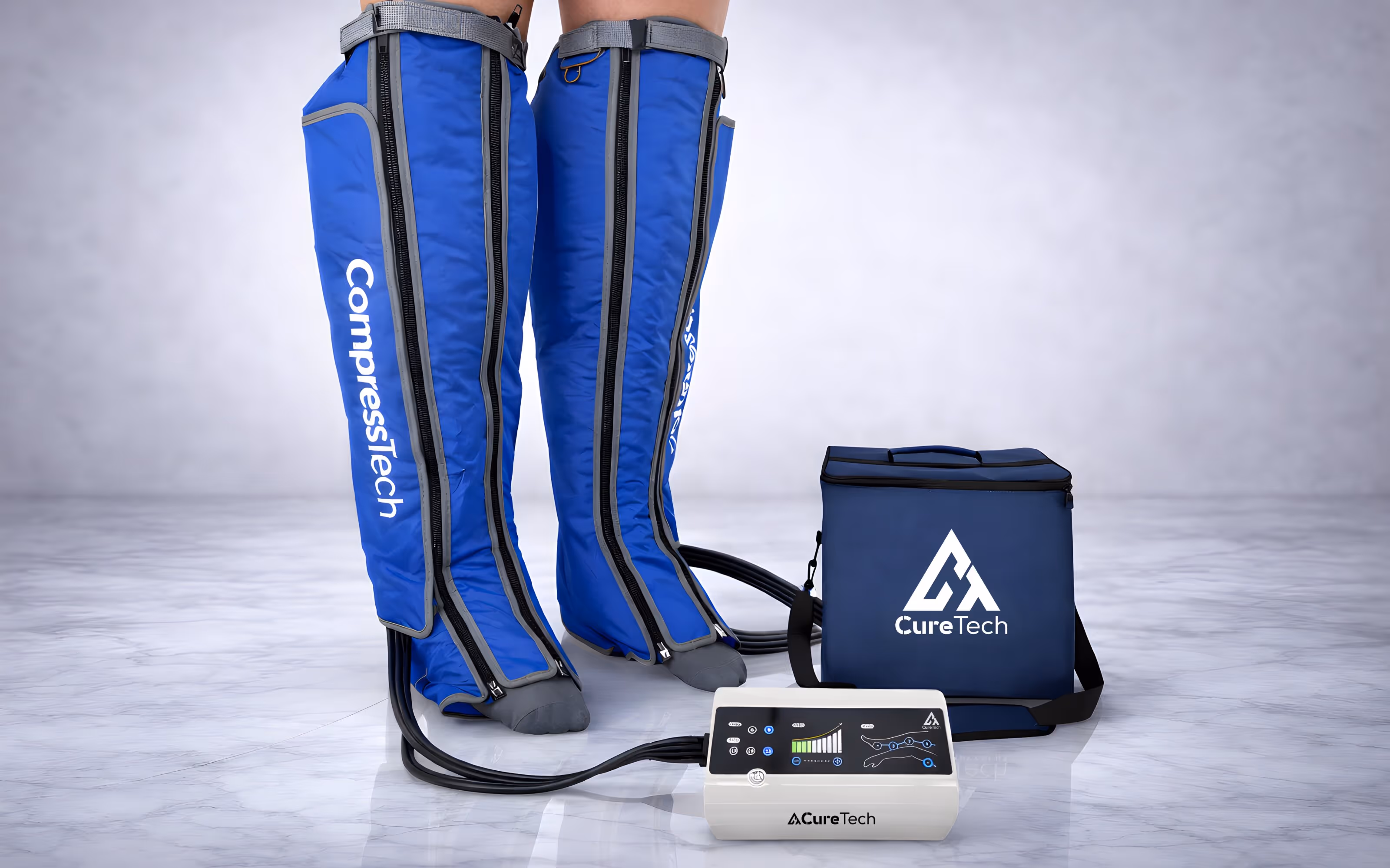 Two legs wearing blue CompressTech compression leg sleeves connected by tubes to a CureTech control unit and carrying case on a marble floor.
