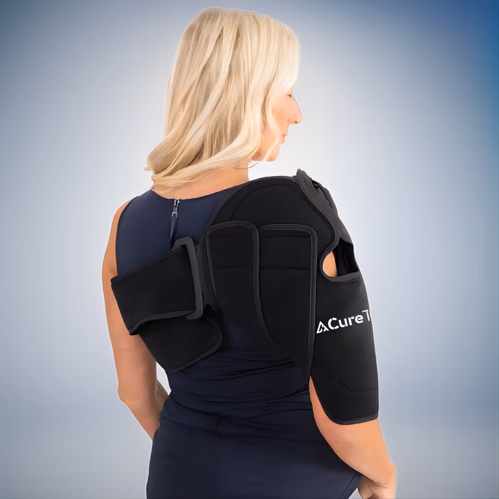 Blonde woman wearing a black CureTec shoulder brace against a gradient gray background.