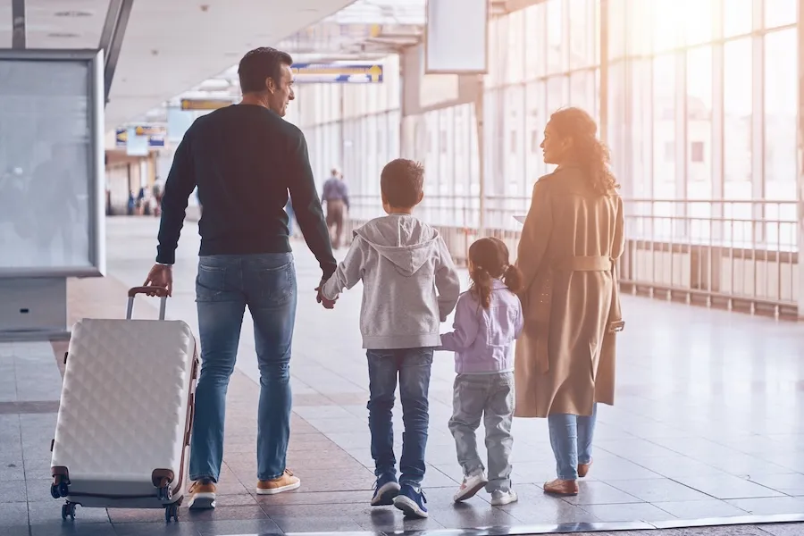 Family an airport walking to the gate.