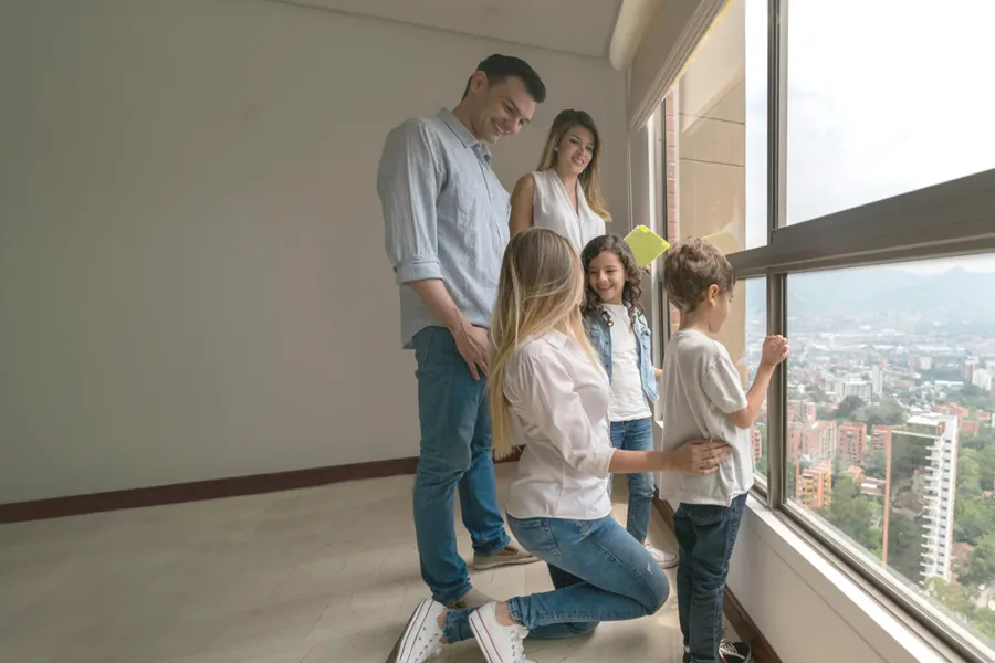 Family looking out their new apartment’s window.