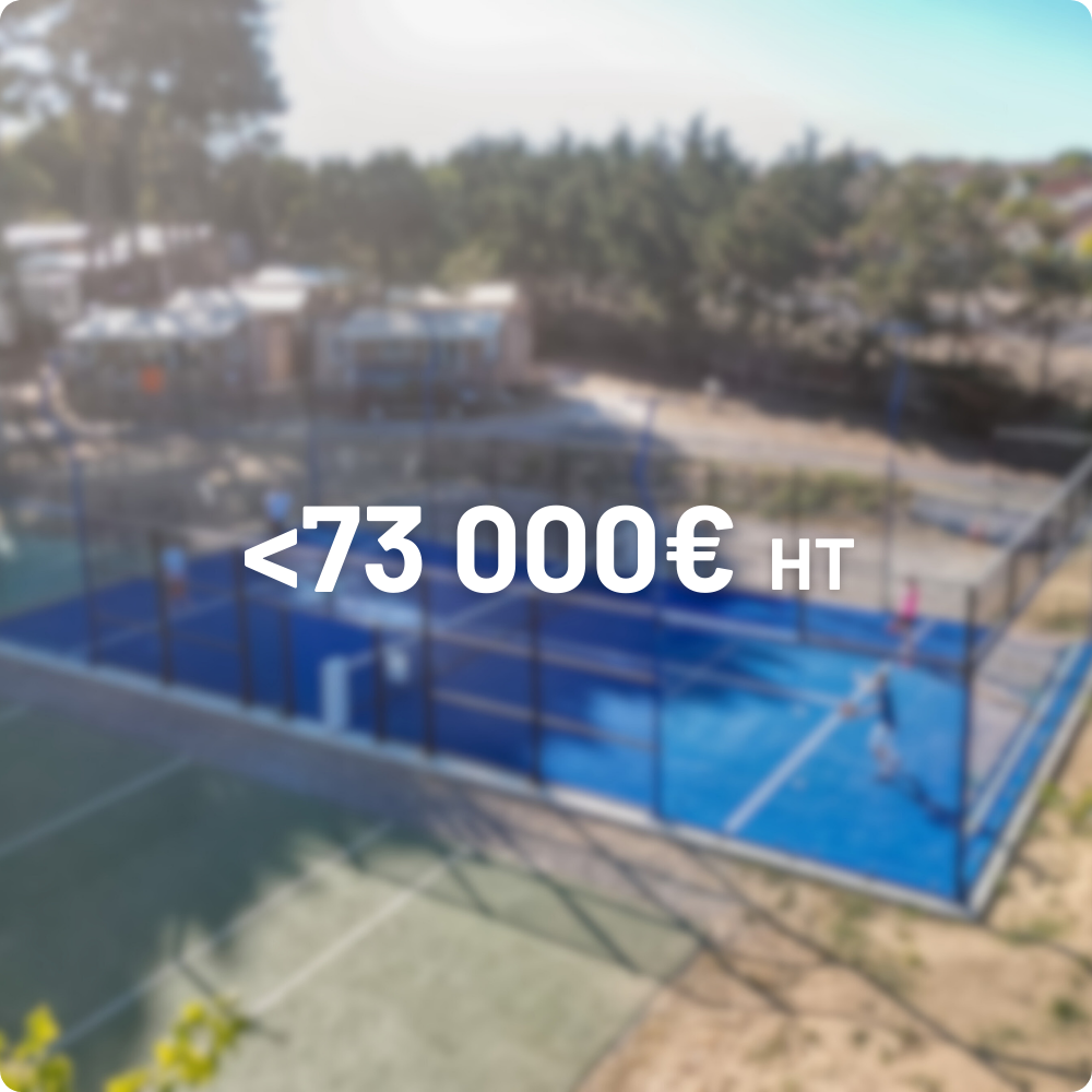 Outdoor fitness area with artificial turf, colorful stepping blocks, and workout bars under a clear blue sky surrounded by trees.