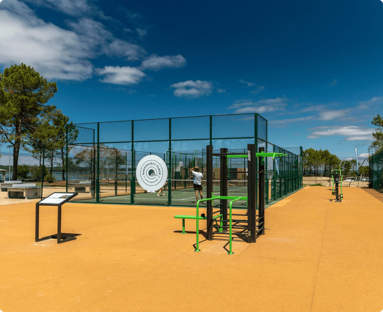 Side-by-side comparison of an empty grassy area and a proposed outdoor gym installation with exercise equipment, including blueprints and 3D model in insets.