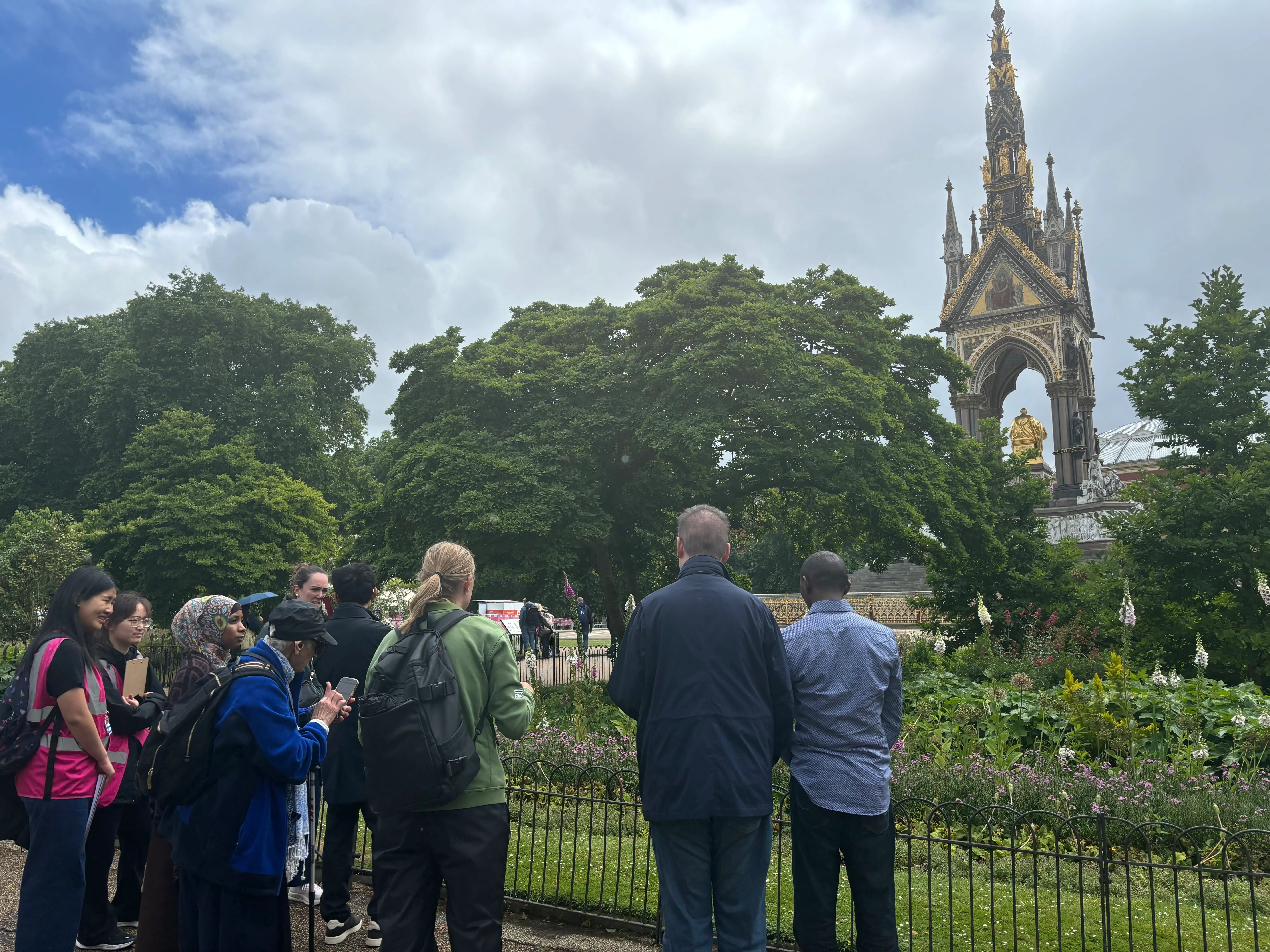Travel Hands participants and volunteers gather near the Albert Memorial during an accessible guided tour of Kensington Gardens.