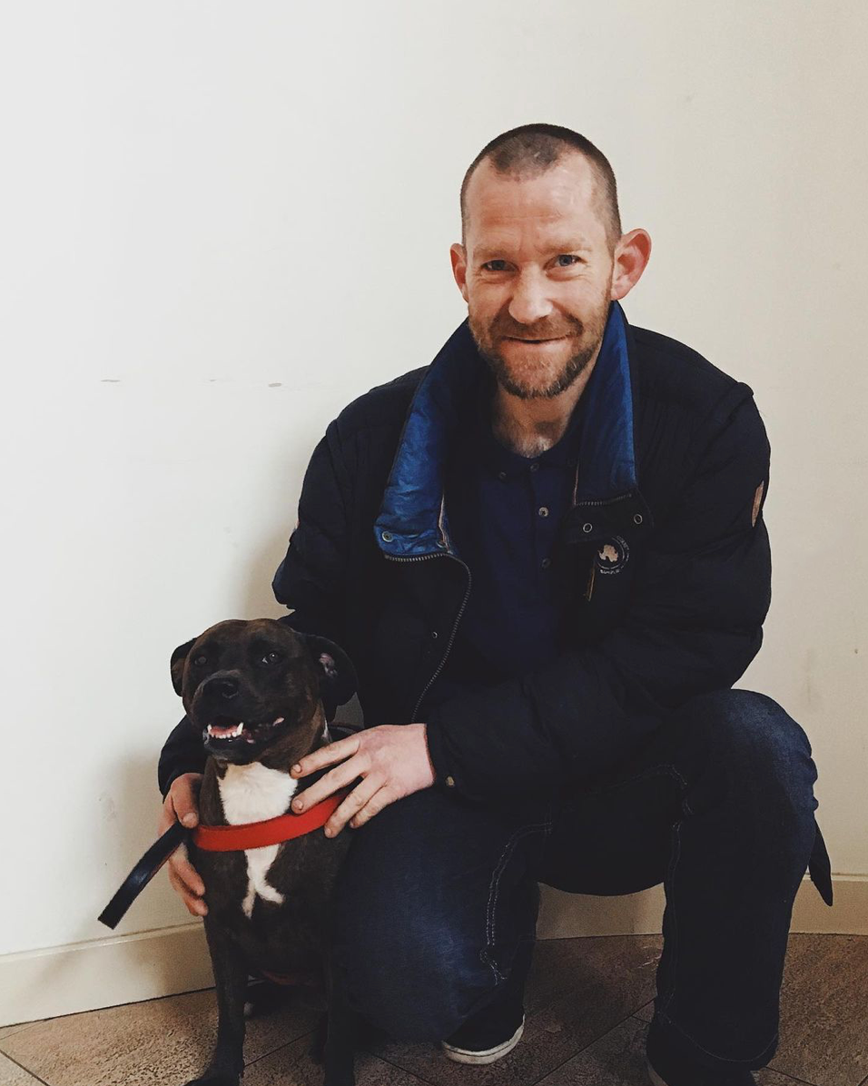 Man kneeling with his dog