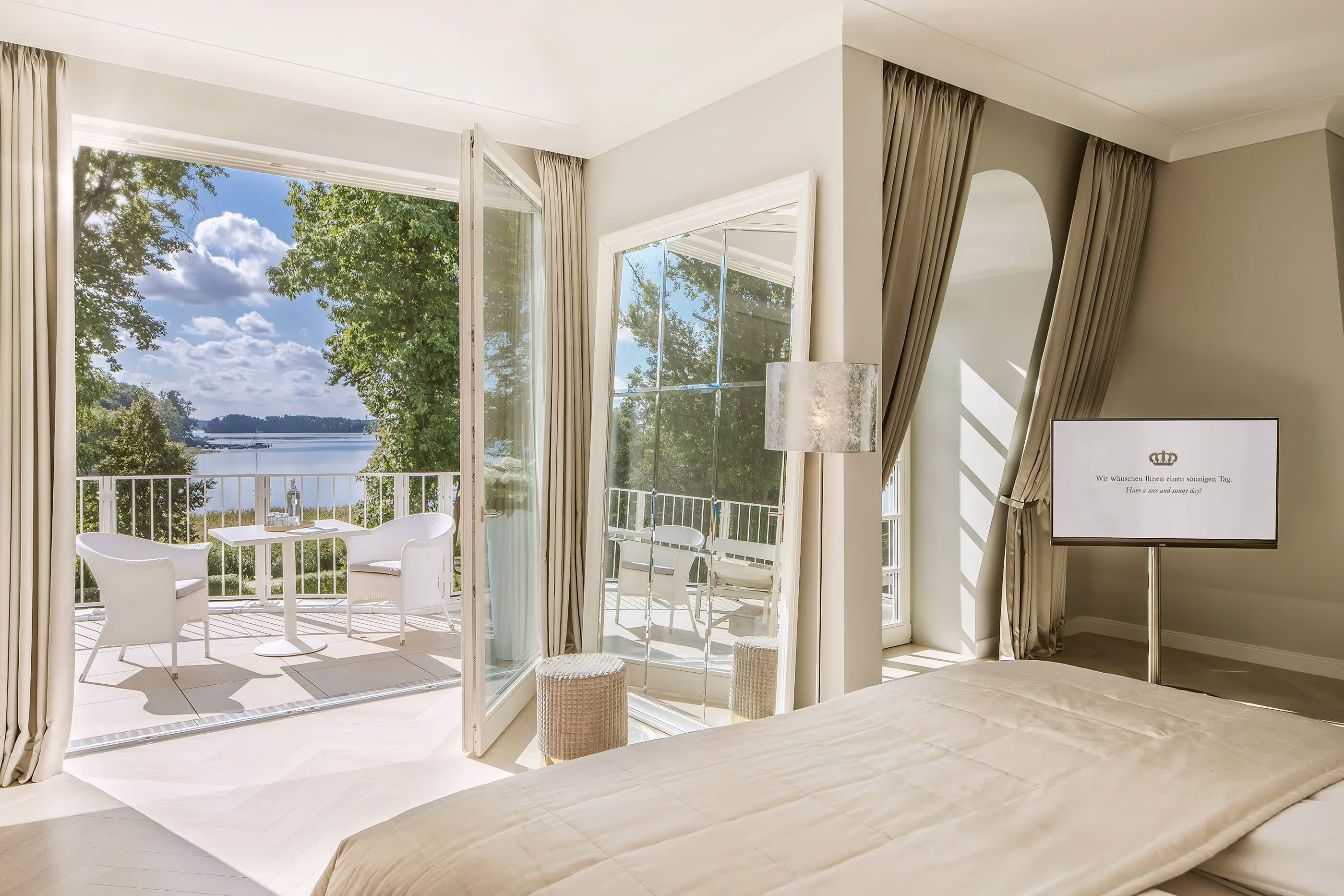 Grand Suite bedroom with a fantastic view of lake Scharmützelsee and the Bad Saarow lakeside promenade - Luxury Hotel & Spa Resort Villa Contessa