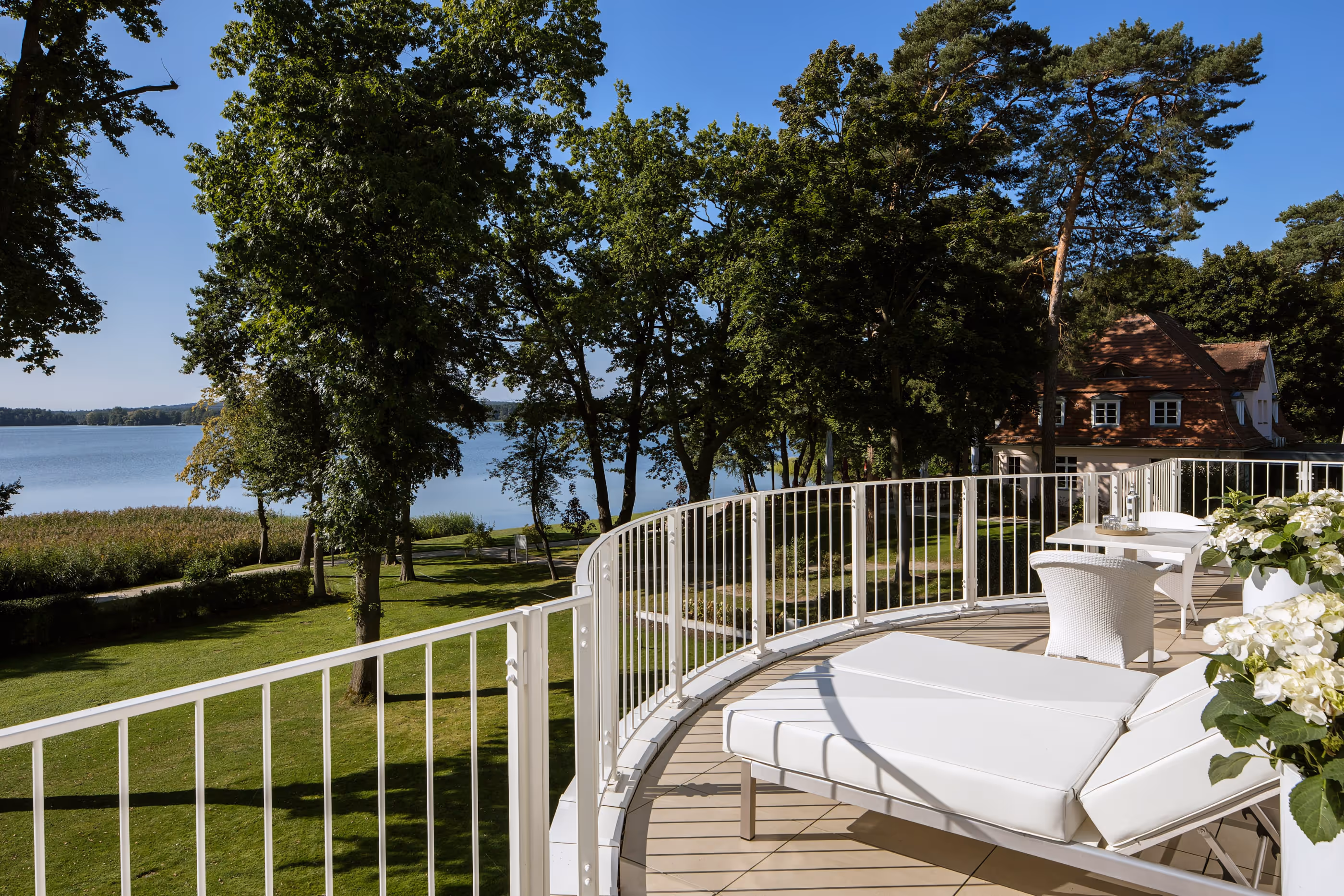 Balcony with lounge sunbeds and stunning views of lake Scharmützelsee - Grand Suite at the Luxury Hotel & Spa Resort Villa Contessa