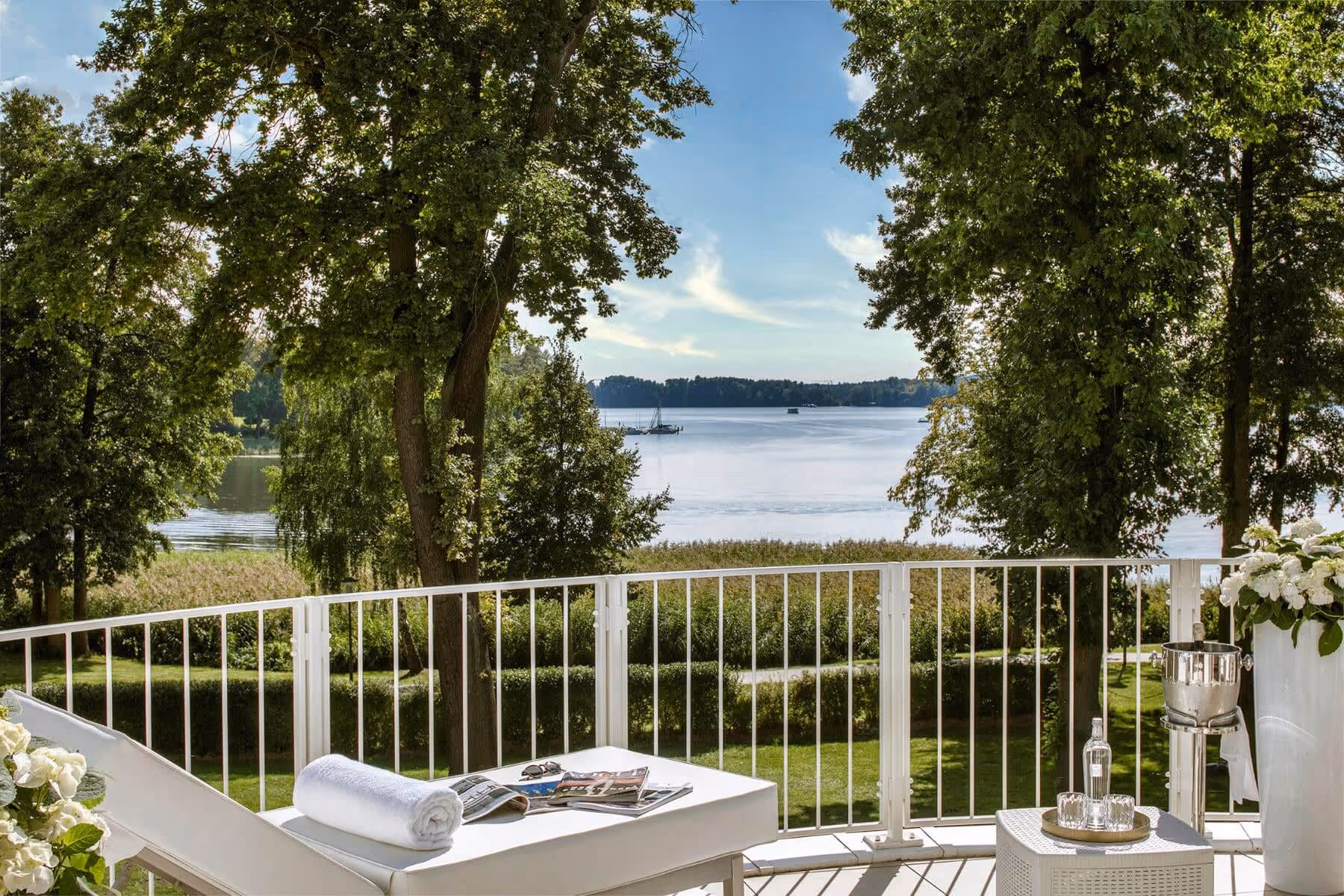Sunny balcony with lounge sunbed and fantastic view of lake Scharmützelsee - Grand Suite at the Luxury Hotel & Spa Resort Villa Contessa
