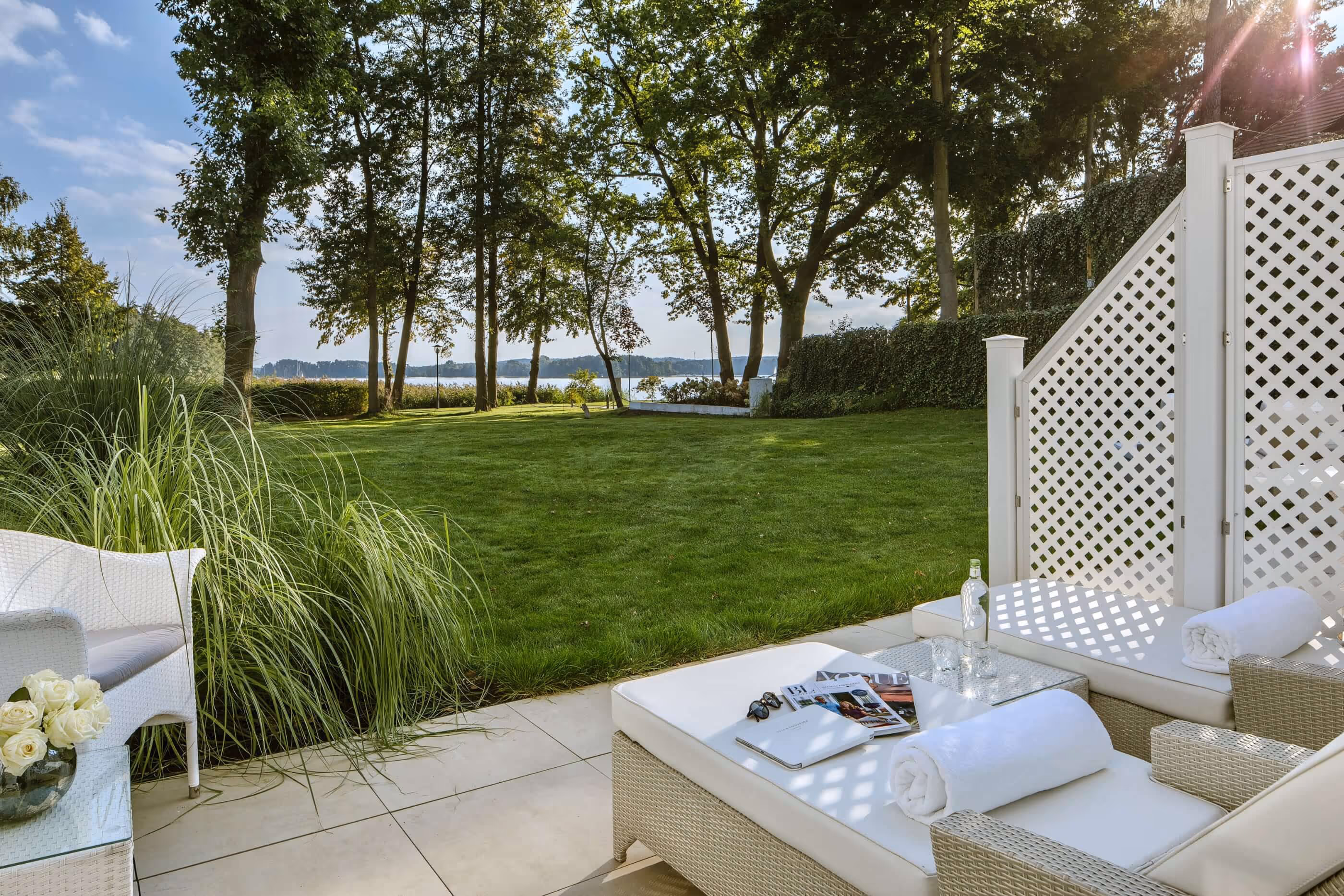 Private terrace with 2 sunbeds and a beautiful view of the garden and lake Scharmützelsee
