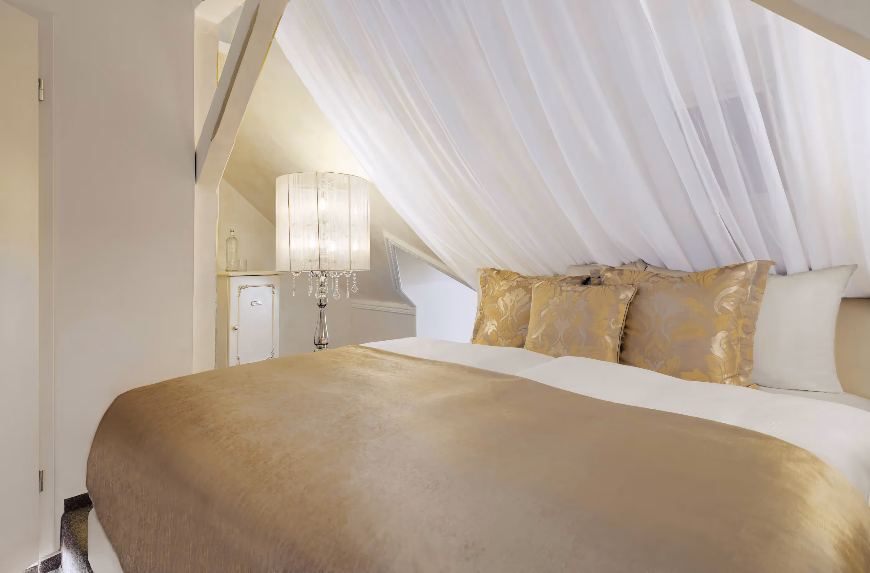 Bed in a maisonette Junior Suite at the 5-star superior hotel & spa resort Villa Contessa