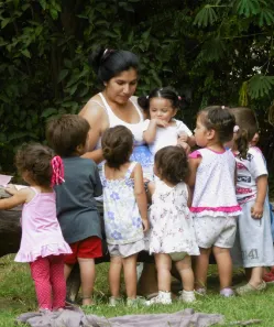 Kindergarten helper and her group of children.