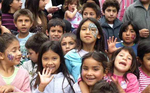 An excited group of children  enjoying the camera attention.