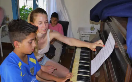 A piano lesson for a teenage boy.