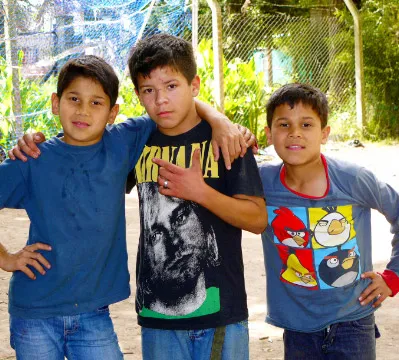 Three boys standing acting cool for the camera.