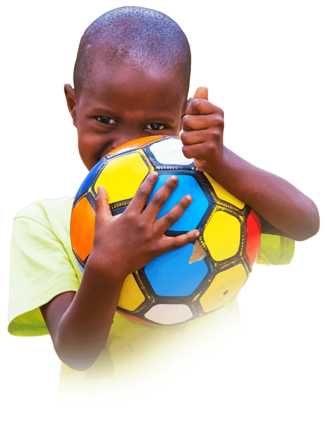 Thumbs up from a Tanzanian boy with a football.