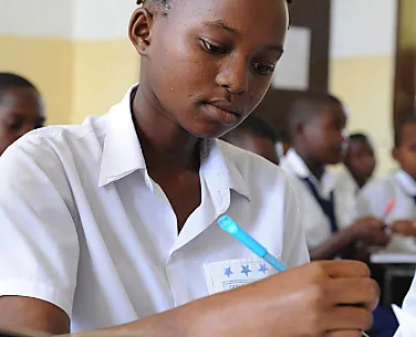 Tanzanian school girl concentrating  on learning.