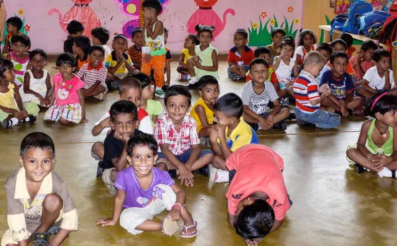 Happy kindergarten children wait for a performance.