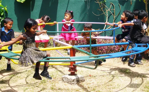 Children playing on a round-about.