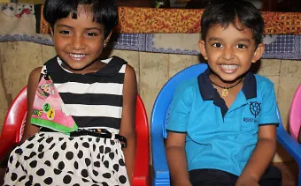 A cute girl and boy excitedly watching on.
