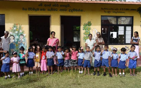 A class standing outside their kindergarten in Sri Lanka.