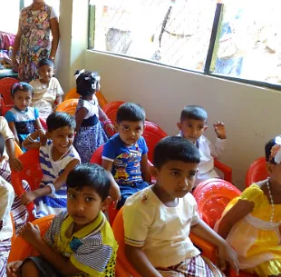 A kindergarten class sat waiting excitedly to hear the visitors.