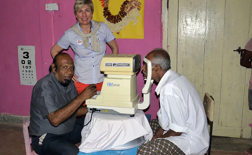 Anslem Nanayakkara helps along at the eye camps watched on by Pertra Hammelmann.