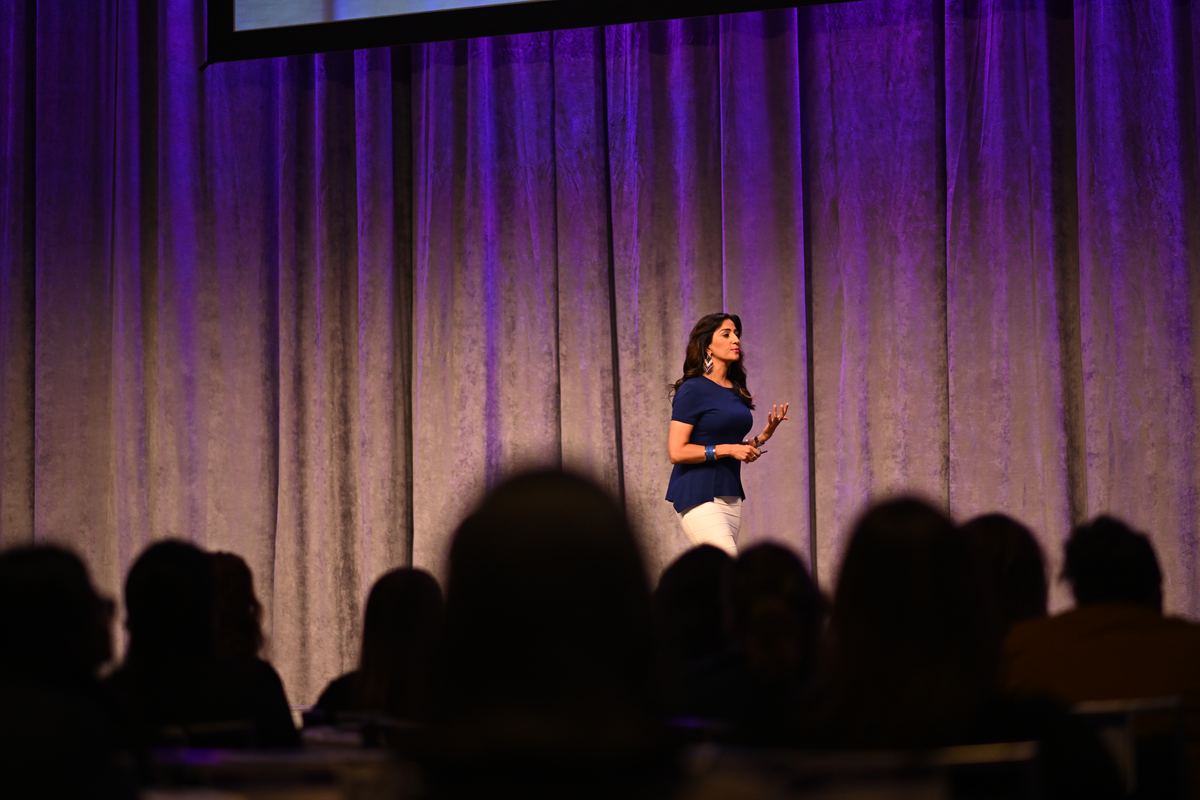 Dr. Shimi Kang delivering a keynote on stage