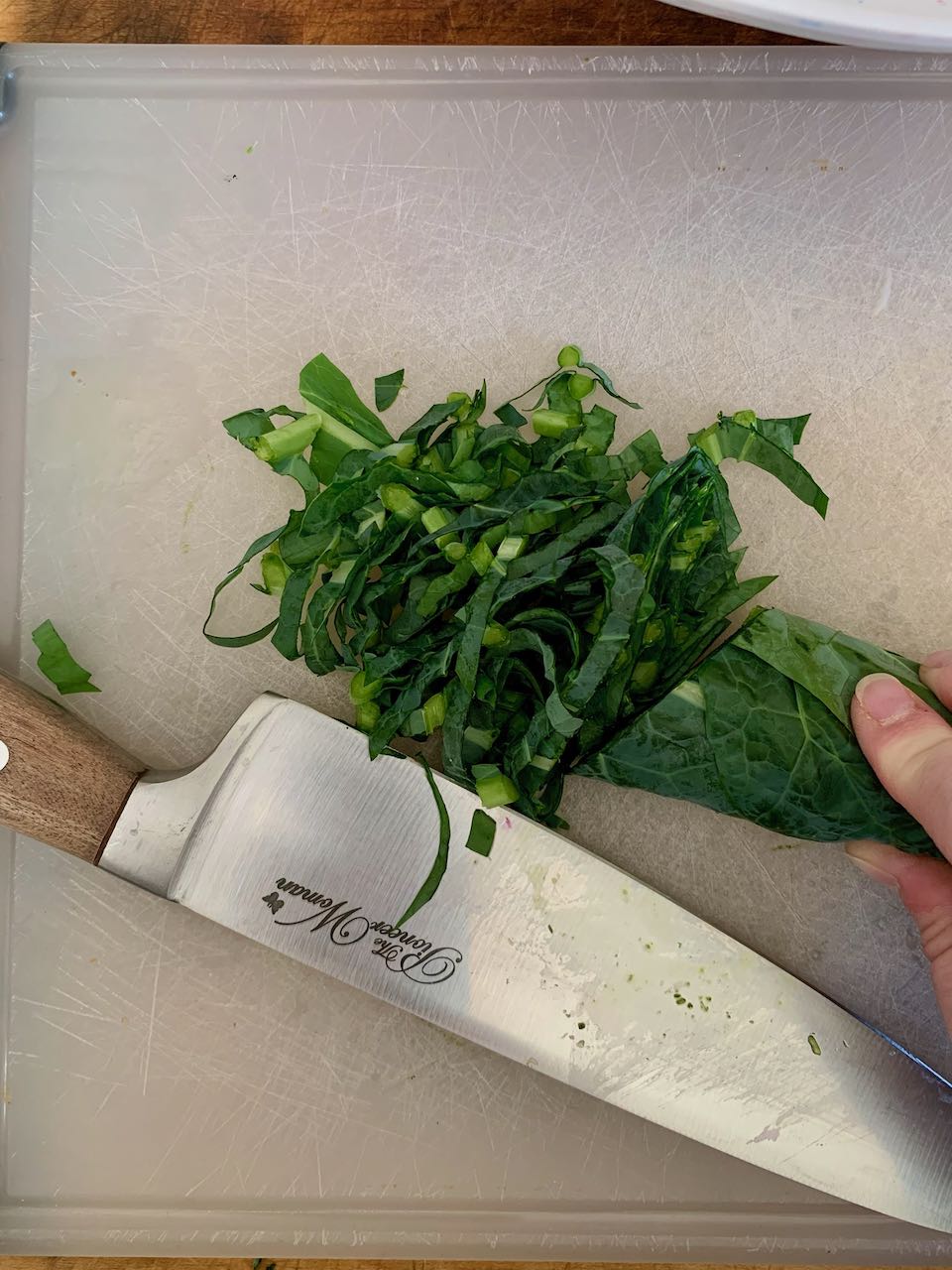 Kale leaves cut in a chiffonade on a cutting board
