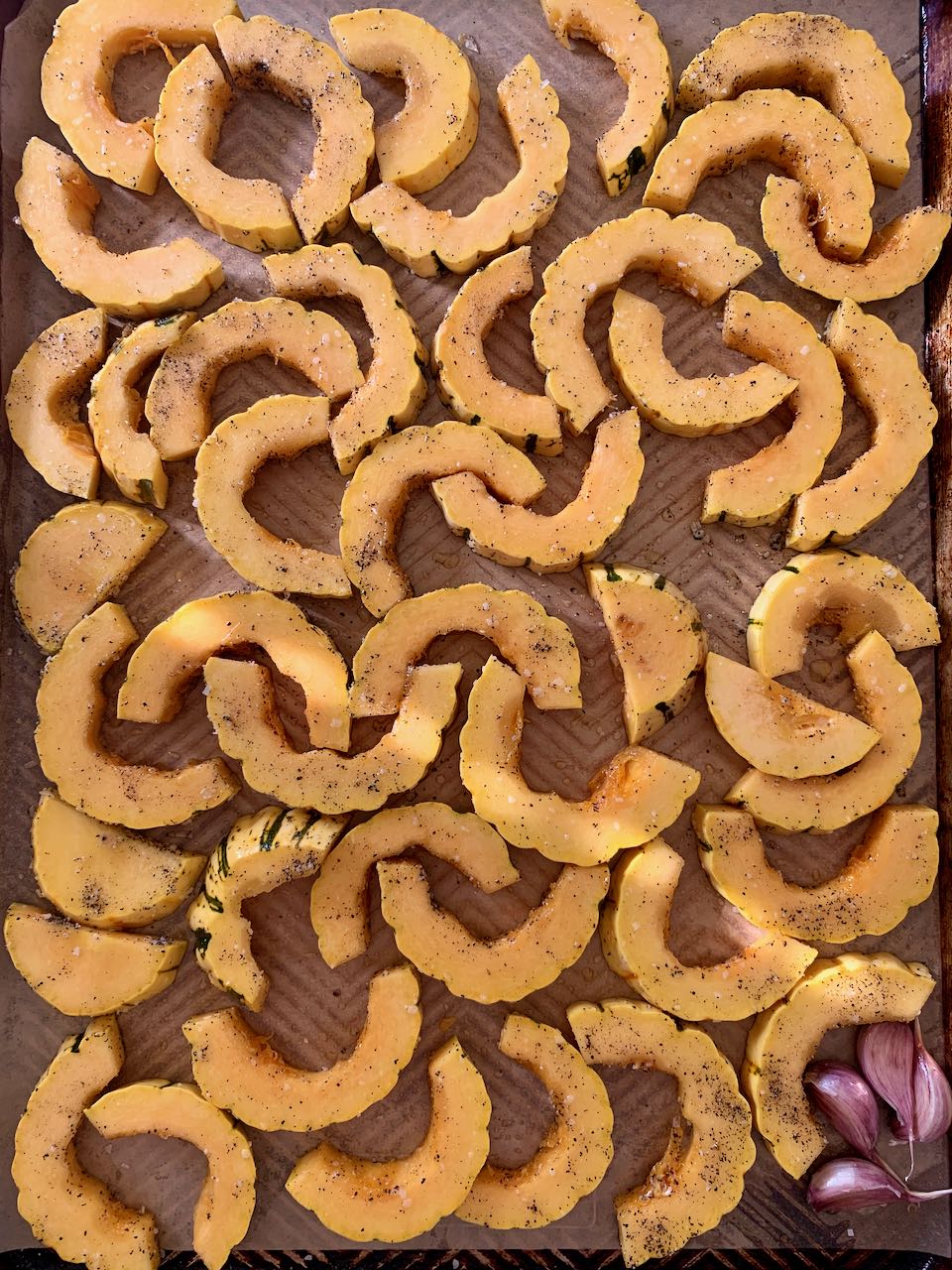 Delicata squash half-moons on a sheet pan